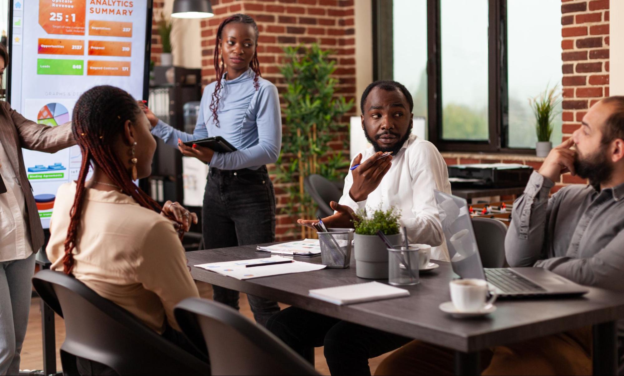 A business consultant reports her presentation explaining the strategy to the co-workers.