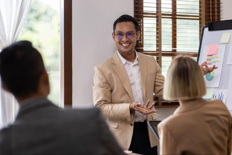 An Asian business consultant using graphs to explain the plan to executives.