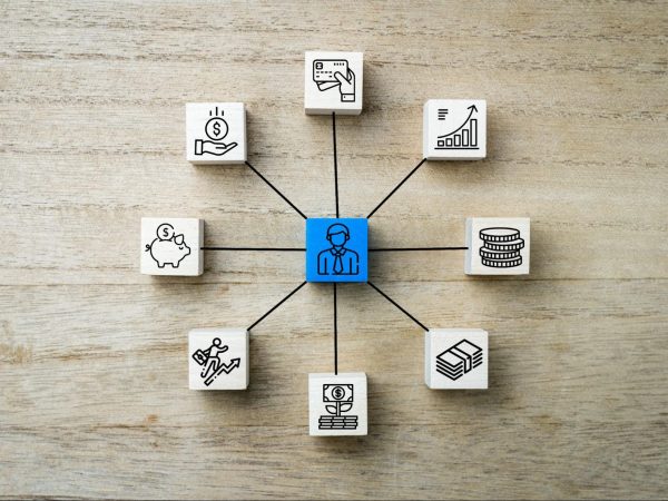 White blocks displaying various resource allocation icons connected to a central blue block with a businessman icon, symbolizing strategic financial planning.